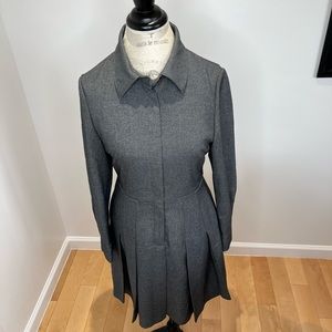 This dress features a gracefully pleated skirt front buttons. Good condition.